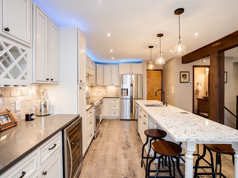 Your gourmet kitchen awaits with marble countertops, custom cabinetry, and a center island perfect for gathering over morning coffee or preparing memorable meals together.