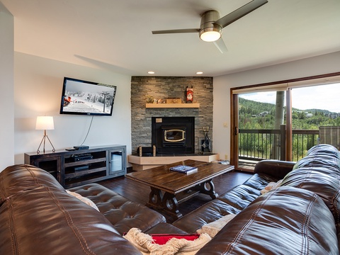 Sink into plush leather sofas and enjoy mountain views from your private balcony, with a cozy fireplace setting the perfect mood for evenings in.