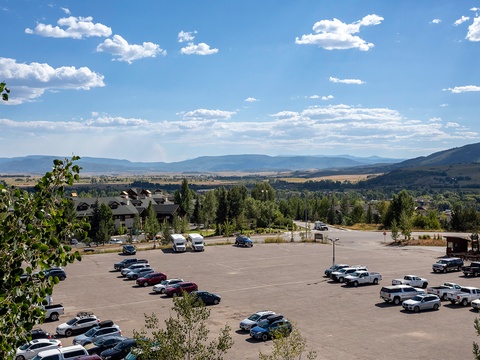 Expansive mountain valley views frame the property's convenient parking area, with scenic vistas extending across the surrounding residential neighborhood and distant peaks.