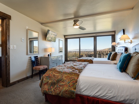 Wake up to breathtaking mountain vistas from your beautifully appointed bedroom, where plush beds and refined furnishings create your personal retreat after a day of adventure.