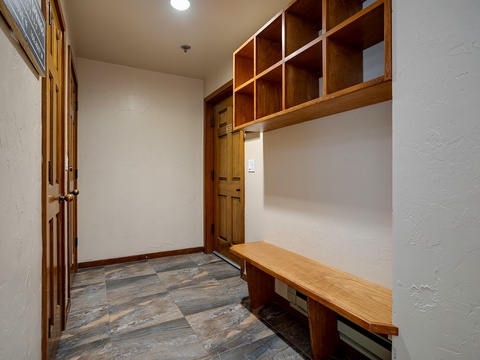 Your private entryway welcomes you with warm wood details, built-in storage cubbies, and a handy bench—perfect for slipping off shoes after a day exploring.
