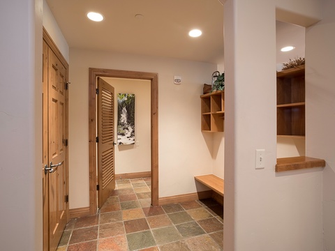 Step into your welcoming entryway with warm wood accents, built-in storage, and a peaceful nature photo greeting you at arrival.