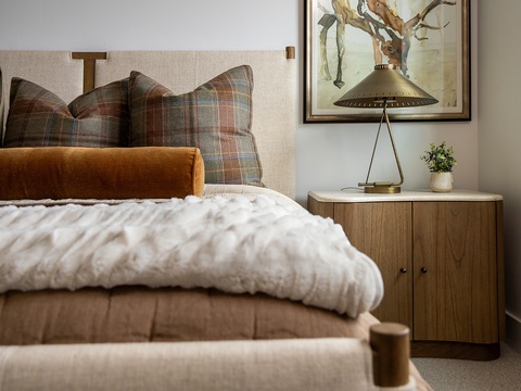 Sink into soft linens and layered textures in your cozy bedroom retreat. The warm plaid accents and thoughtful décor create a restful space where you'll drift off peacefully.