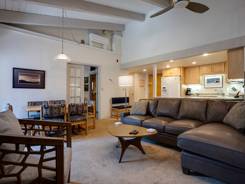 Settle into your inviting living space where a plush leather sectional awaits after adventurous days. Cook in the open kitchen, dine together, and unwind beneath soaring ceilings—your mountain retreat feels like home.