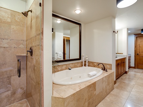 Soak in your own jetted tub surrounded by elegant travertine tile, or step into the walk-in shower for a refreshing rinse after a day exploring nearby adventures.