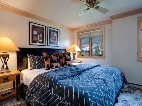 Sink into crisp linens and plush pillows in this inviting bedroom, where mountain views frame your mornings and warm lamps set the perfect evening mood.