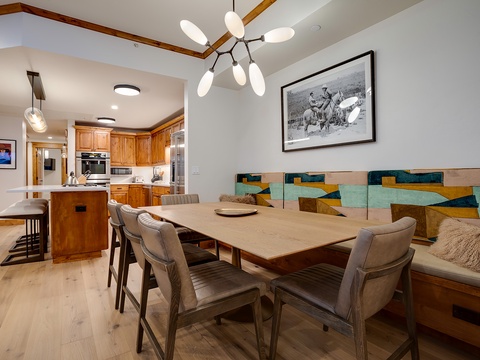 Gather around this inviting dining table for memorable meals with your group. The open layout connects you to the chef in the full kitchen, while cozy built-in seating adds warmth to your evenings together.