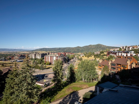 An aerial view showcasing the property's setting in a scenic mountain community with easy access to local roads and trails.