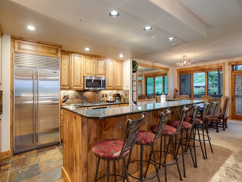 Gather around the spacious island with granite countertops, modern appliances, and warm wood cabinetry that makes meal prep a pleasure. Natural light pours through the windows inviting you in.