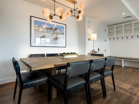 Gather around this elegant dining table under modern lighting—perfect for sharing meals and making memories with your group.