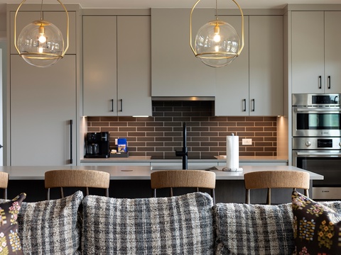 Gather around your sleek kitchen with elegant lighting and modern appliances, ready for meals and memorable conversations.