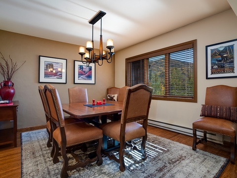 Gather around your private dining table for meals and conversation, with warm wood tones, mountain views through wide windows, and Colorado-inspired décor setting a welcoming tone.