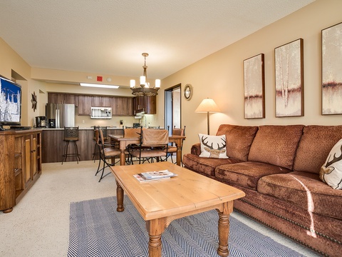 Your cozy mountain retreat features a spacious living area with plush seating, an open kitchen ready for home-cooked meals, and rustic decor that makes you feel instantly at home.