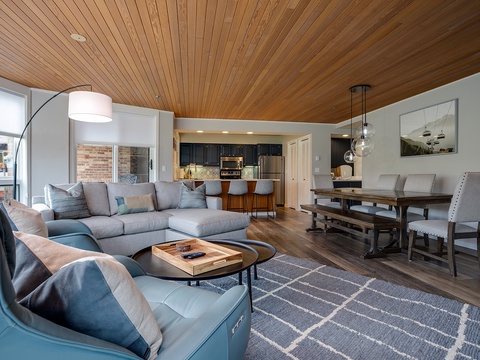 Unwind in your spacious open-concept living area, where natural wood ceilings and modern comforts invite you to feel right at home.