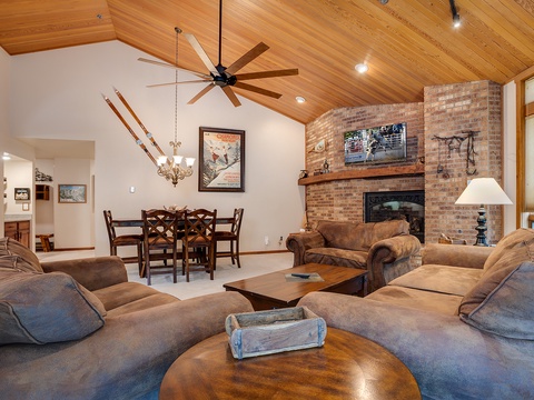 Sink into plush sofas by the warm glow of your stone fireplace, while vaulted wood ceilings and mountain-inspired décor create a welcoming alpine retreat.
