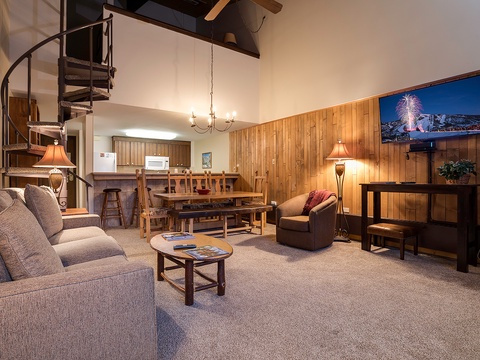 Relax in your spacious mountain retreat with soaring ceilings, cozy wood accents, and a spiral staircase leading to the loft. Unwind on plush seating after a day on the slopes.