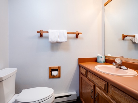 Your private bathroom features fresh towels, a vanity with counter space, and all the essentials for a comfortable stay.