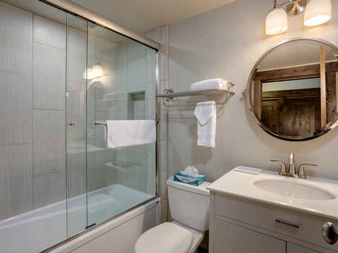 You'll appreciate this crisp, well-appointed bathroom with its gleaming shower, plush towels, and elegant fixtures—everything you need to refresh after a day of exploring.