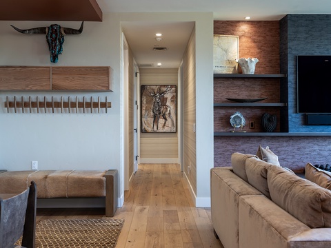 Sink into plush leather sofas as warm wood tones and rustic details create your perfect mountain retreat. Contemporary comfort meets authentic charm in this stylish living space.