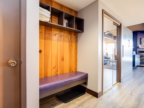 Step into your mountain retreat through a thoughtfully designed mudroom with built-in storage cubbies and a cushioned bench—perfect for organizing gear after your adventures.