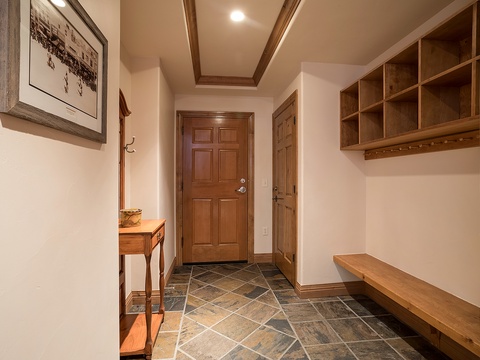 Step into your private entryway with custom built-in storage, elegant slate flooring, and warm wood accents—everything you need to feel instantly at home after a day of adventure.