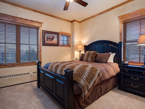 Sink into plush bedding beneath warm lighting and natural wood accents. Your cozy retreat features luxurious textures, ample storage, and peaceful views to help you unwind completely.
