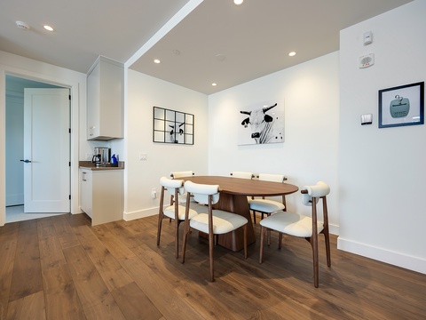 Gather around the warm wood dining table for meals and conversation in this bright, contemporary space with stylish modern touches throughout.