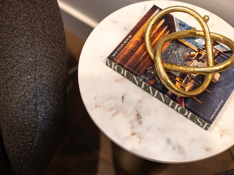 A marble-topped side table offers a stylish accent—perfect for resting your morning coffee while you browse a favorite book.