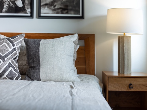 Sink into soft linens and plush pillows after a day of exploring. Your bedside lamp sets the perfect mood for a cozy evening in.