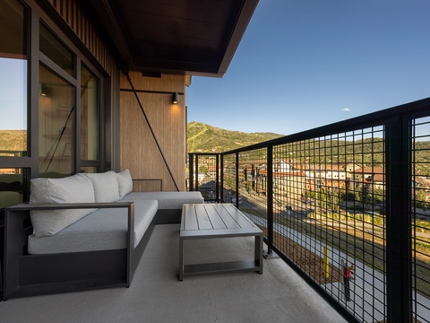 Step outside to your private balcony, where comfortable seating awaits and breathtaking mountain vistas stretch across the horizon, creating the perfect spot to unwind and soak in the natural beauty.