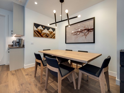 Gather around your private dining table for memorable meals together in this bright, modern space with sleek lighting and stylish accents.