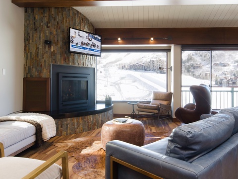 Sink into plush leather seating by your cozy fireplace and gaze at spectacular ski slopes right outside your window—your perfect mountain retreat awaits.