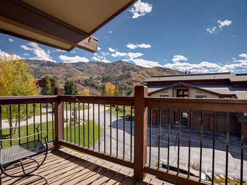 Step onto your private balcony and breathe in the crisp mountain air as you gaze at stunning alpine peaks framed by vibrant autumn foliage.
