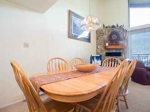 Gather around this spacious wooden dining table, where your group can share stories and mountain-view meals together in this bright, open setting.
