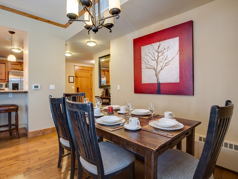 Gather around this welcoming dining table for memorable meals together. The warm wood tones and tasteful artwork create an inviting atmosphere where you can savor your morning coffee or share evening dinners.