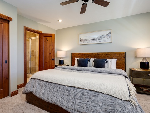 Your peaceful retreat features a plush king bed with soft linens, warm wood accents, and gentle lighting. Unwind beneath the ceiling fan after a day of adventure and drift into restful sleep.