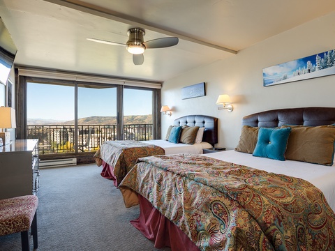 Wake up to stunning mountain vistas from your comfortable bedroom, where two plush beds and calming decor create the perfect retreat after your daily adventures.