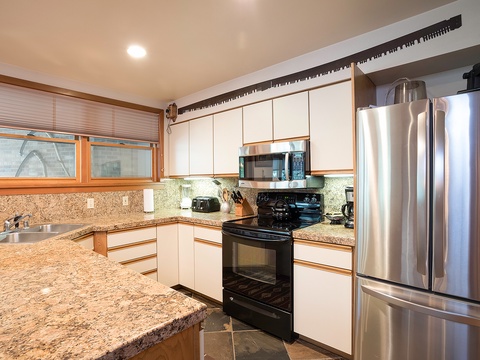 Your fully equipped kitchen features granite countertops, stainless steel appliances, and plenty of space to prepare delicious meals during your stay.