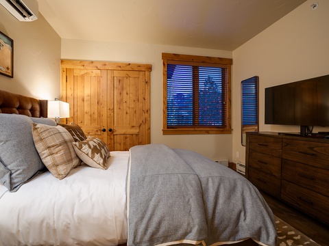 Sink into crisp linens and plush textures in your cozy mountain bedroom. Warm wood accents and thoughtful touches create the perfect retreat after your alpine adventures.