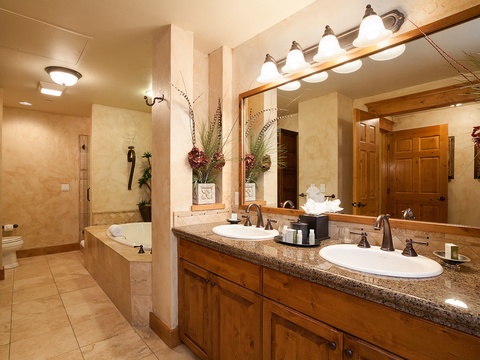 Your private spa-like bathroom offers double vanities with granite counters, a soaking tub, and a spacious walk-in shower—everything you need to relax and refresh in style.