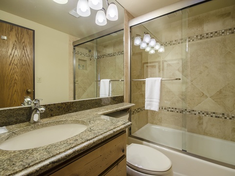 Step into your beautifully updated bathroom, where polished granite counters, designer tile, and soft towels await. Fresh lighting and a sleek tub-shower combo make unwinding effortless.