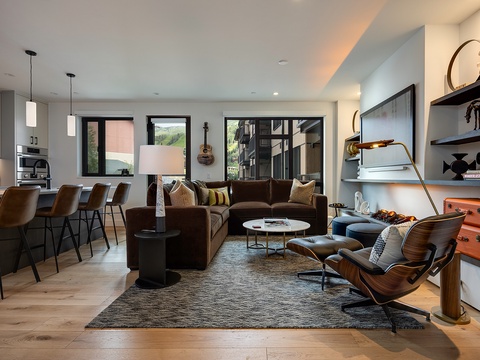 Step into your open-concept living space where rich textures and thoughtful design create an inviting retreat. Plush seating and warm wood tones set the perfect stage for relaxing after a day of mountain adventures.