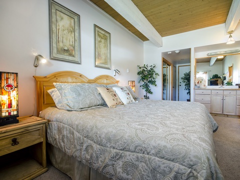Unwind in your serene retreat featuring vaulted wood-beam ceilings, a plush king bed, and thoughtful touches like soft lighting and plants to help you feel right at home.