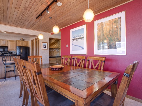 Gather around this handsome dining table where warm wood tones and pendant lighting create the perfect setting for your mountain meals and evening game nights.