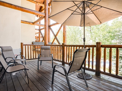 Relax on your private deck surrounded by lush greenery, where rustic timber beams frame your peaceful retreat. Unwind in shaded comfort with morning coffee or evening conversations.