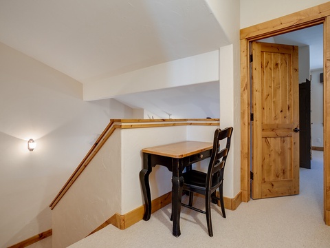 A quiet workspace awaits in this bright landing area, where you can catch up on emails or plan your next adventure under the soft glow of ambient lighting.