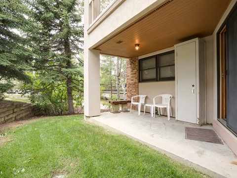 Your private covered patio opens to a lush lawn and mature trees, perfect for morning coffee or evening relaxation in the fresh mountain air.