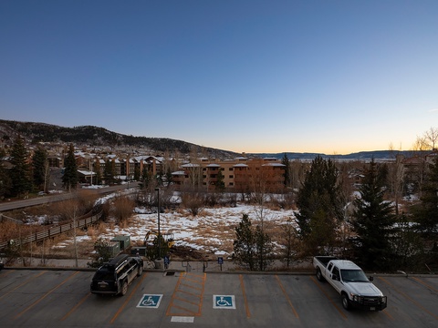 The property sits within a scenic mountain community, surrounded by forested hillsides and residential areas with accessible parking available on-site.