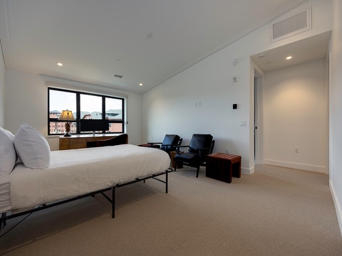Step into your serene retreat with plush carpeting, crisp linens, and a cozy seating area—perfect for unwinding after a day of adventure.