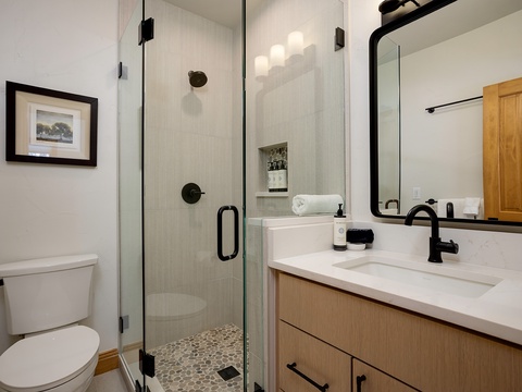 Step into your modern, spa-like bathroom with a spacious walk-in shower, sleek fixtures, and fresh towels waiting for your comfort.